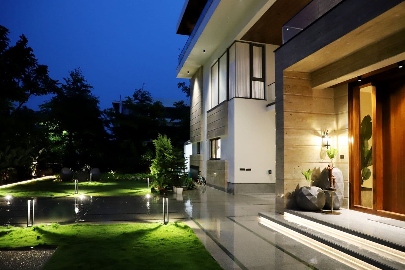 Modern house illuminated at night with warm exterior lights