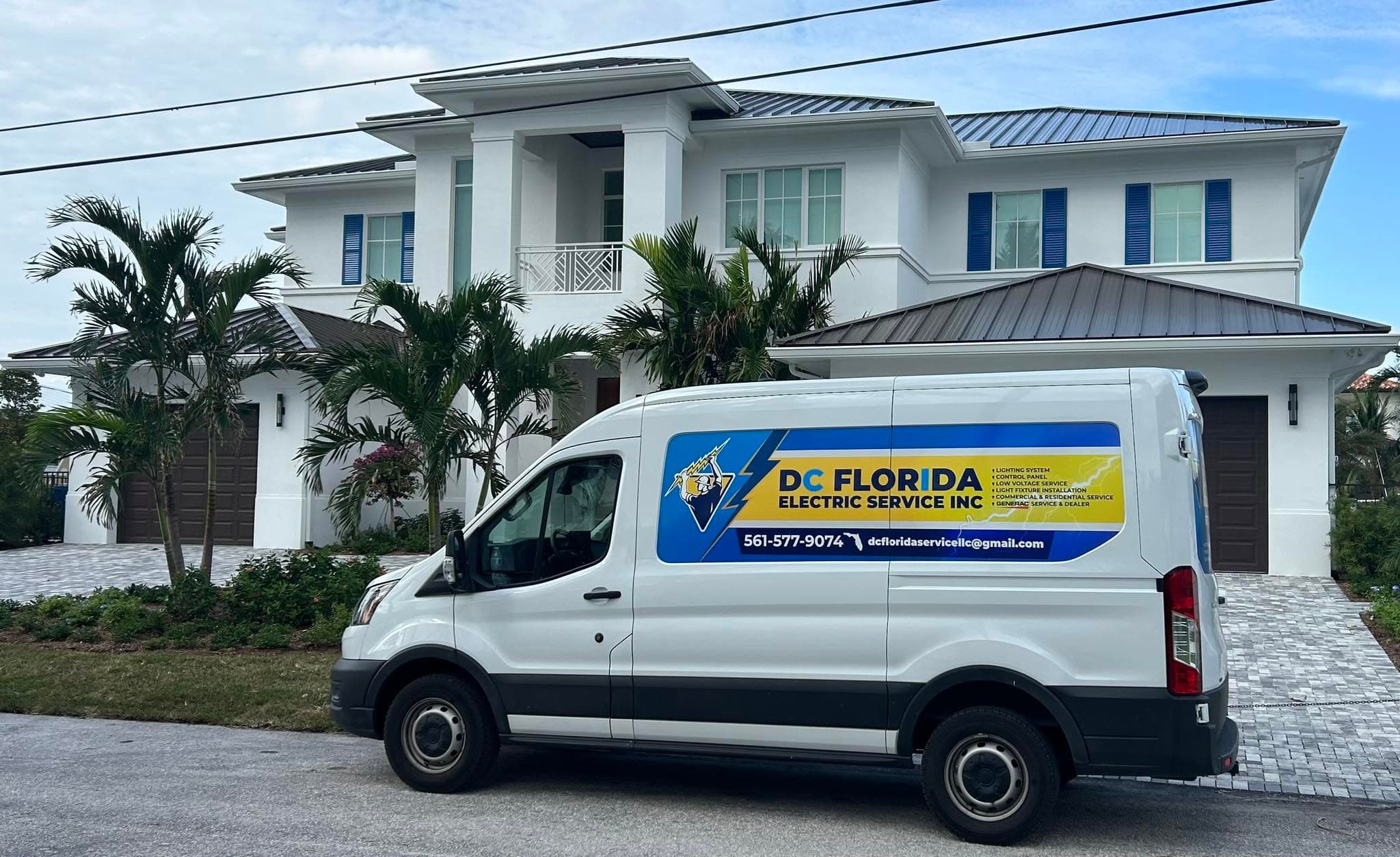 DC Florida Electric Service van parked in front of a white two-story home with palm trees